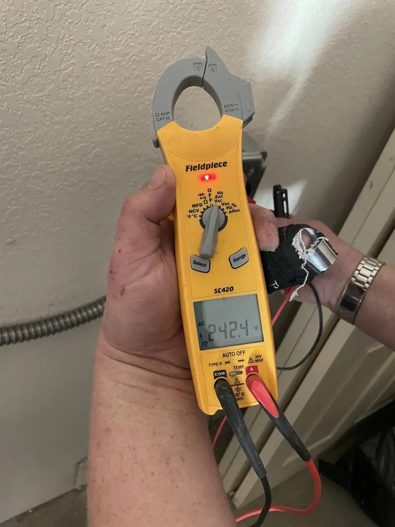 Voltage testing with clamp meter during Whole House Surge Protector in Biloxi